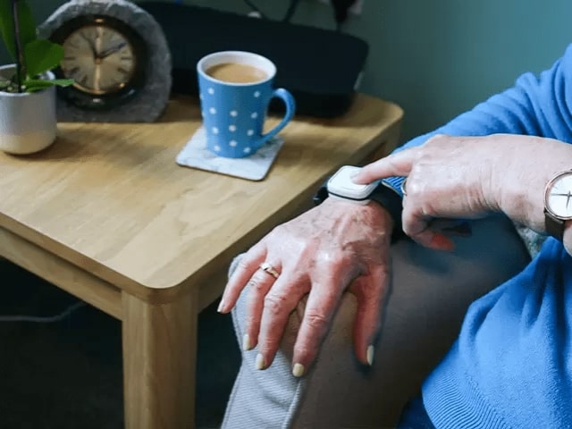 Lady pressing her fall detector