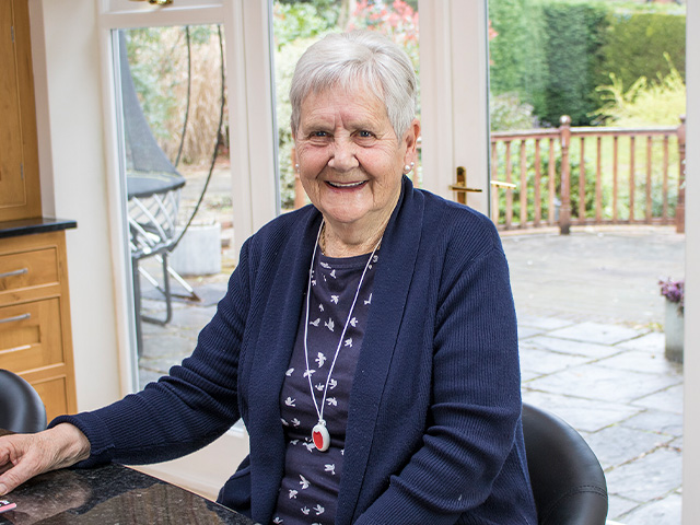 Lady wearing her MyAmie personal alarm